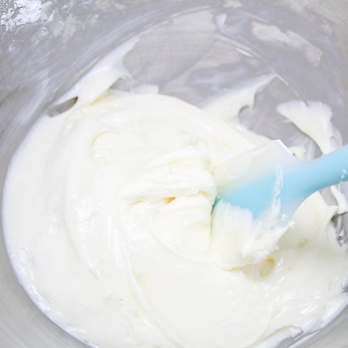 Creamy cheesecake filling in a mixing bowl.