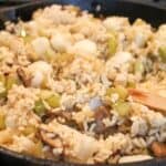 Rice Dressing in a black skillet.