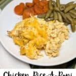 Chicken and rice, green beans, and carrots on a white dinner plate.