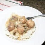 Salisbury steak meatballs in a white dish with a fork.