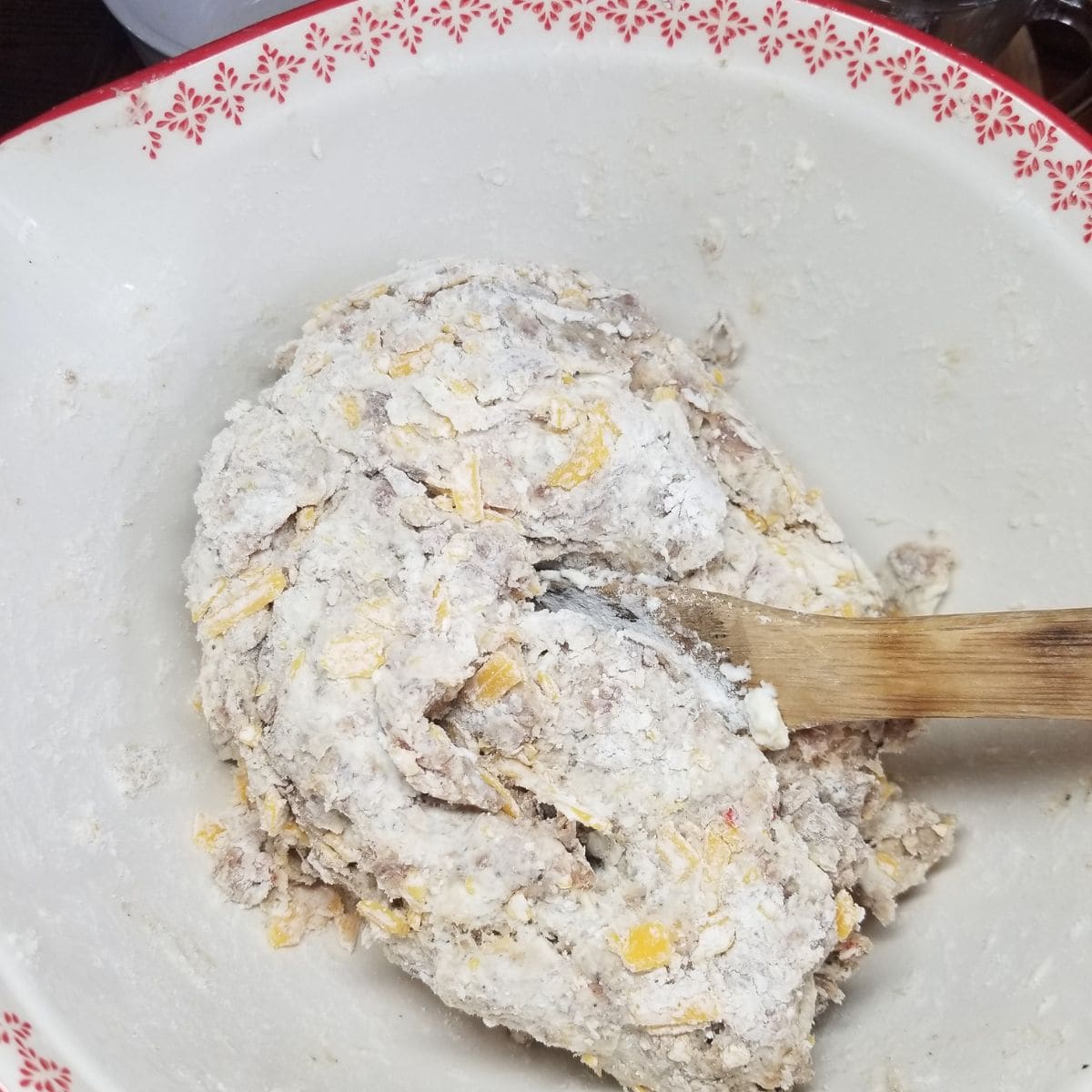 Ingredients needed and mixed for making sausage balls.