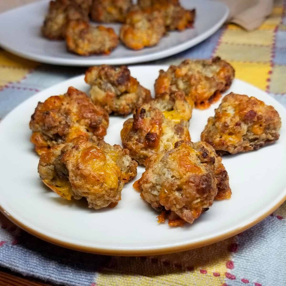 Sausage balls on a white plate and platter.