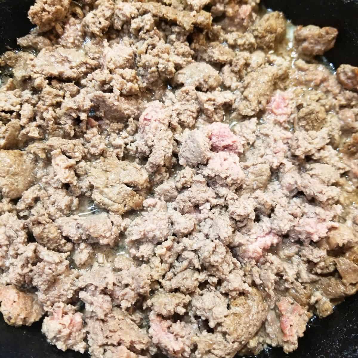 Cooking the ground beef.