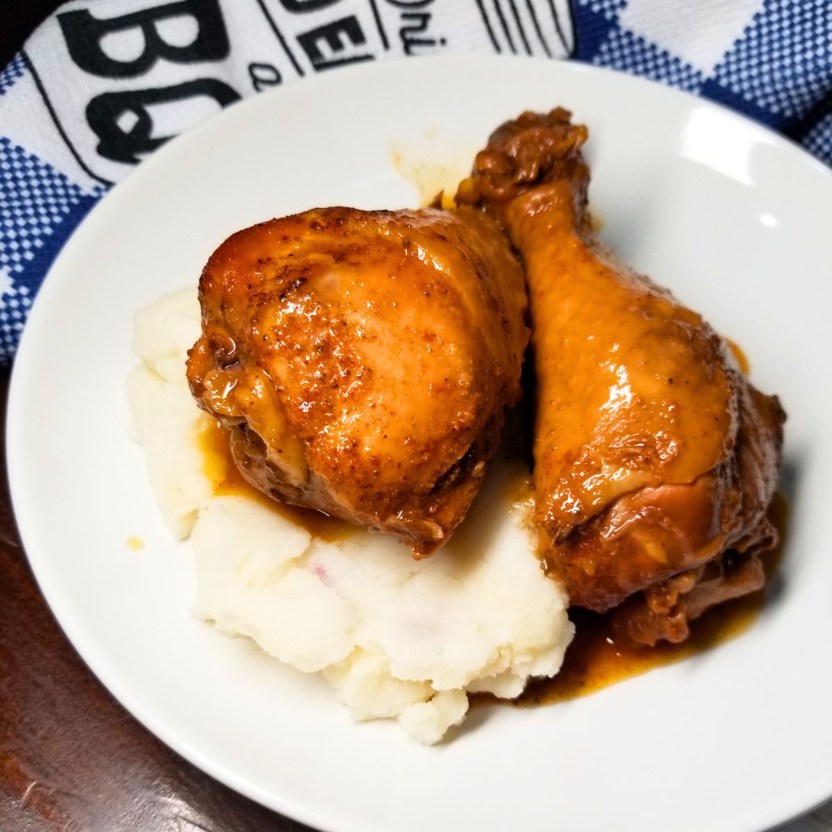 Close-up of tender Slow Cooker BBQ Chicken Legs coated in BBQ sauce.