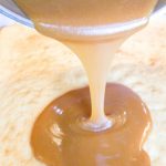 Pour caramel frosting over cooled cake