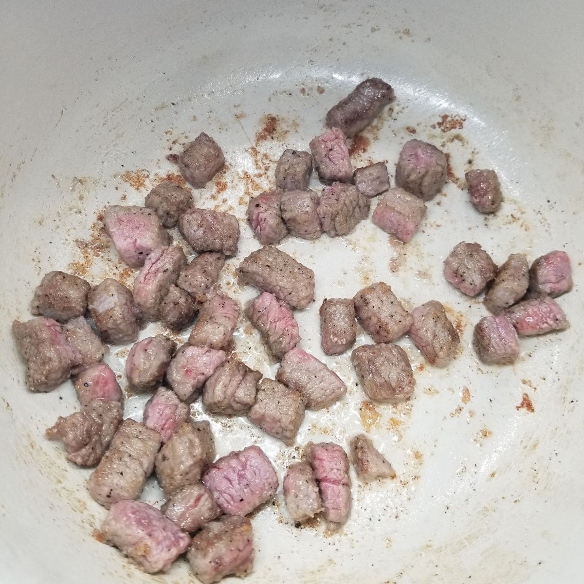 Browning stew beef in a large pot.