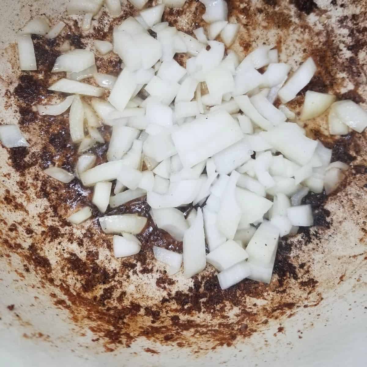 Cooking onions down for the beef stew recipe.