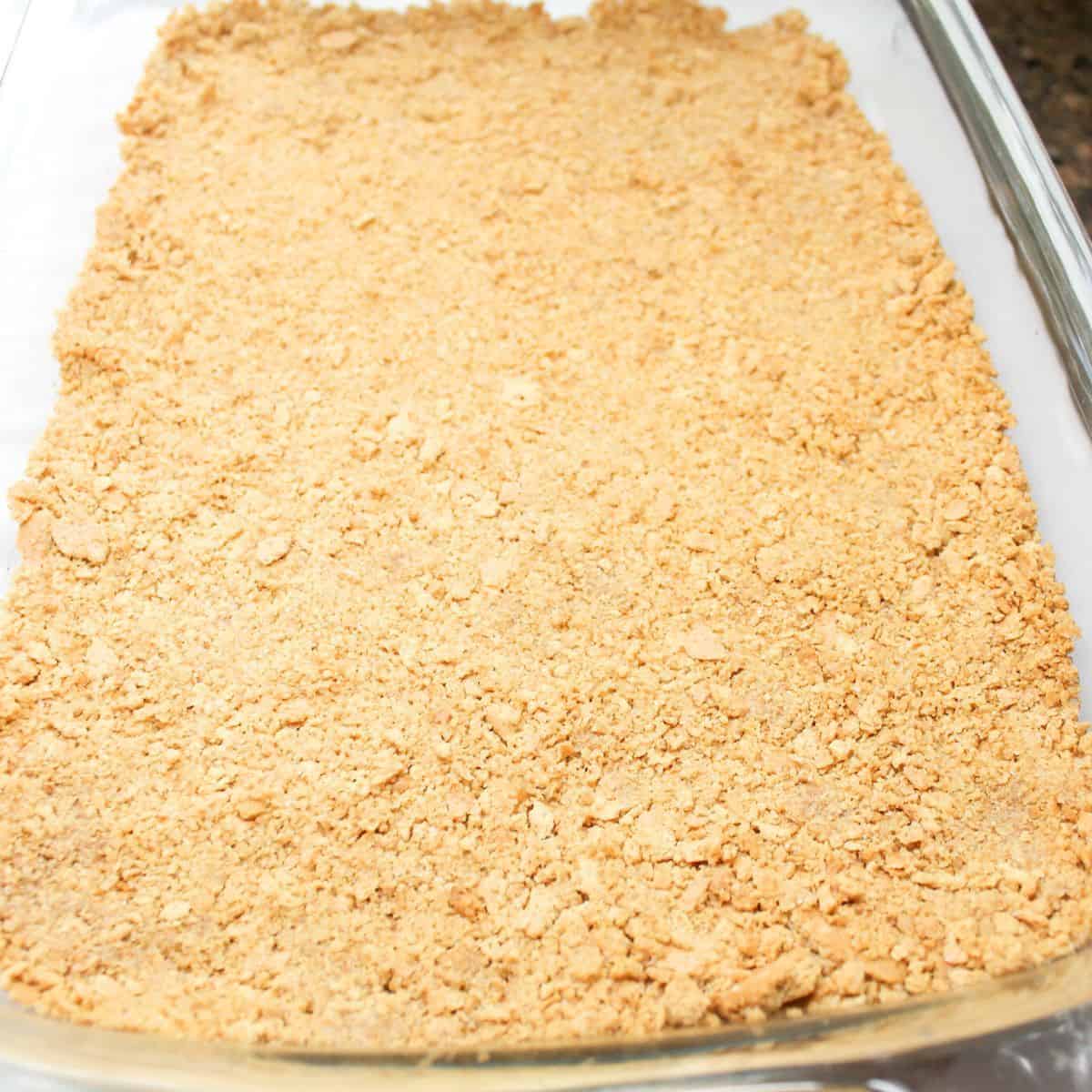 Crushed graham crackers, melted butter, and sugar mixed together for cheesecake crust.