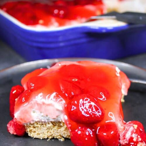 Strawberry cheesecake cut into squares ready to serve.