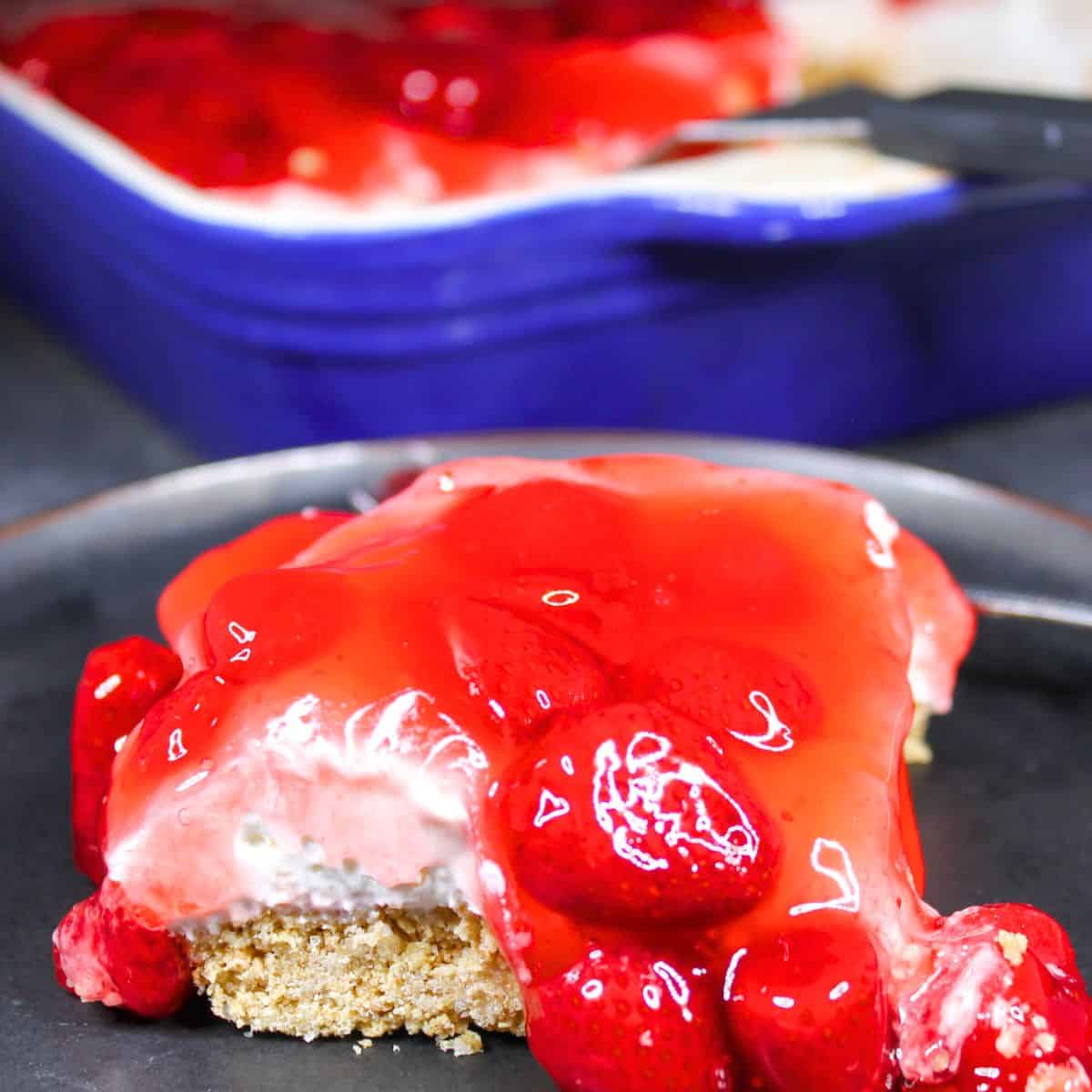 Creamy strawberry cheesecake bars with graham cracker crust and sweet strawberry topping.