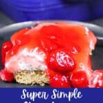 Chilled strawberry cheesecake bars cut into squares for serving with text overlay.