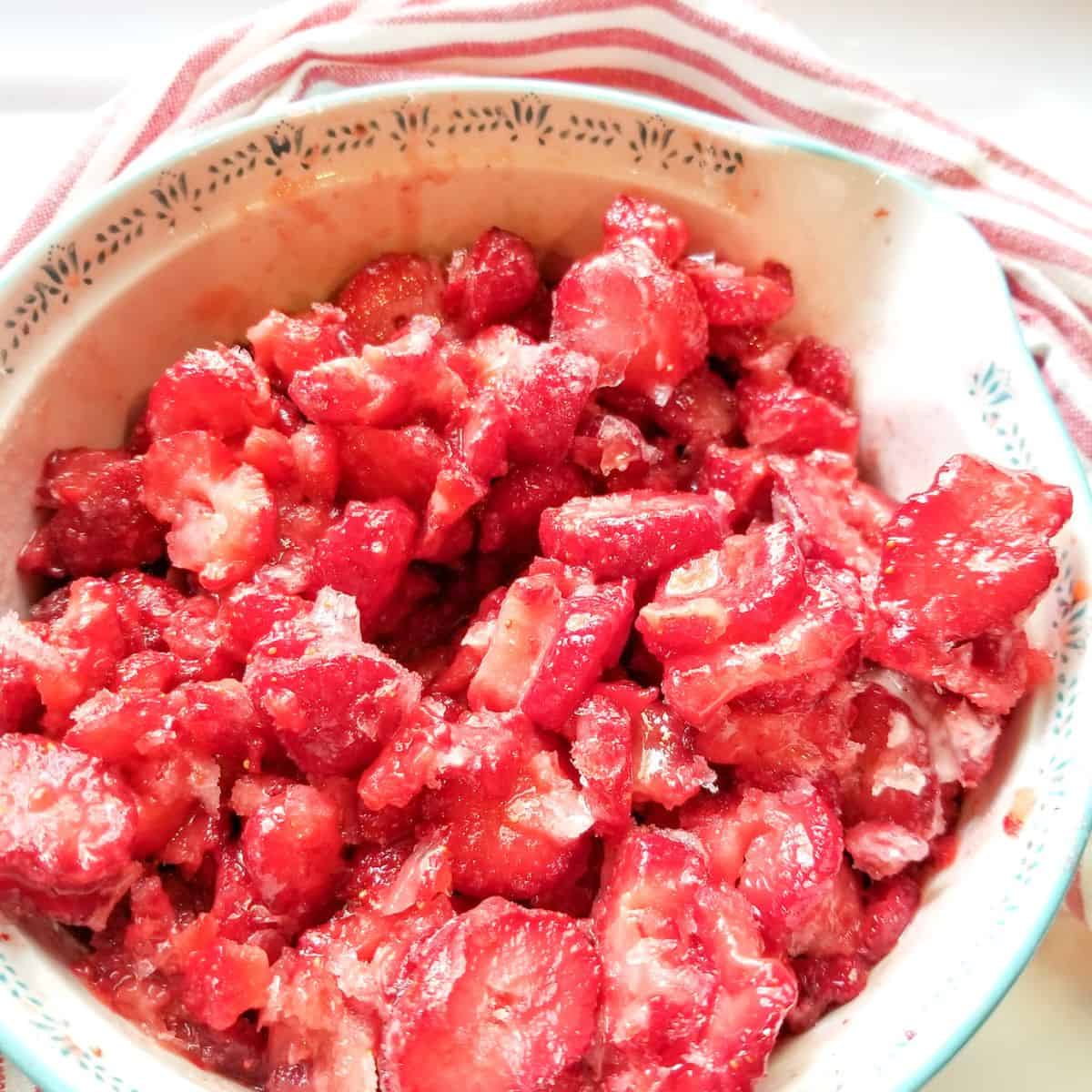 Sliced strawberries in a bowl.