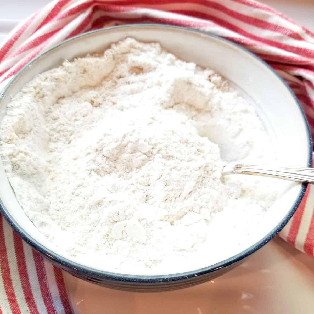 Dry ingredients for making the topping. with a red and white dish cloth.