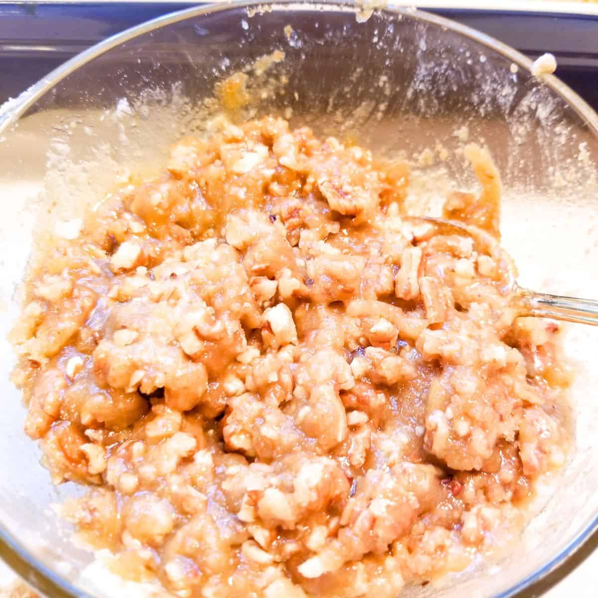 The topping for the casserole in a bowl  with a spoon.