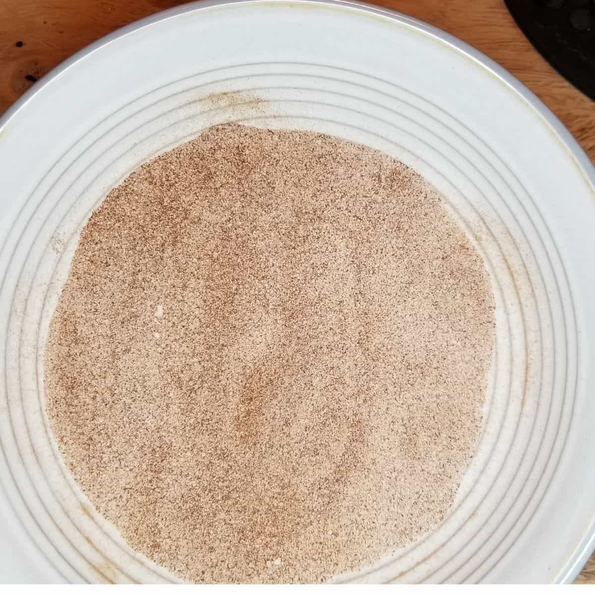 Cinnamon sugar mixed in a bowl for sprinkling over the unbaked dumplings before baking.