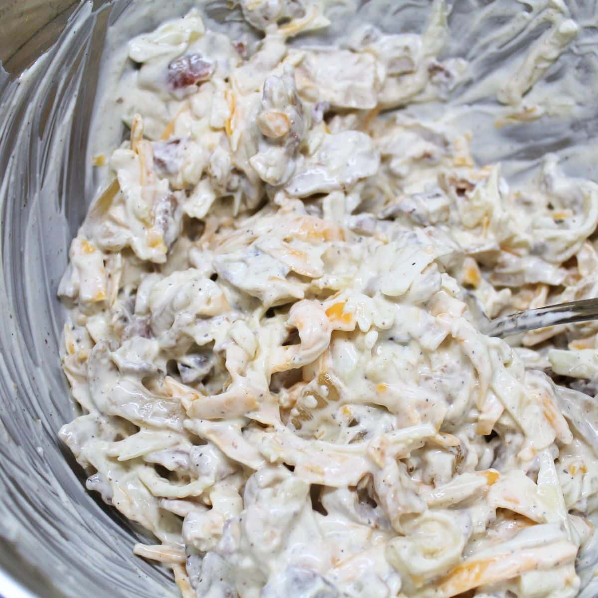 Ingredients combined in a bowl for the cheesy topping.