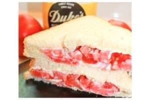 Southern Tomato Sandwich cut in half on a plate.