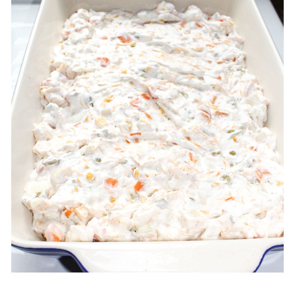 The mixed ingredients in a blue and white casserole dish.
