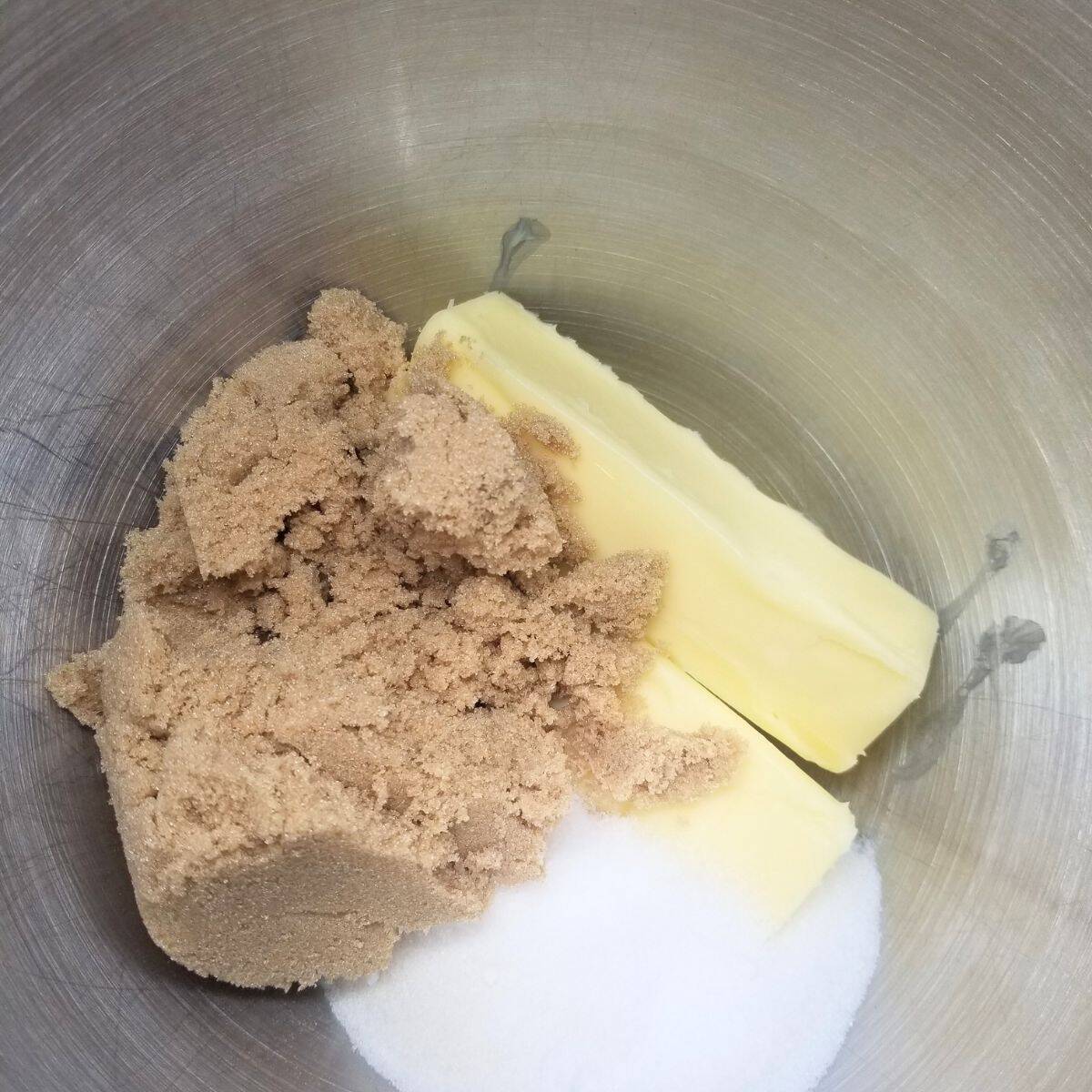 Butter and sugars in a mixing bowl.