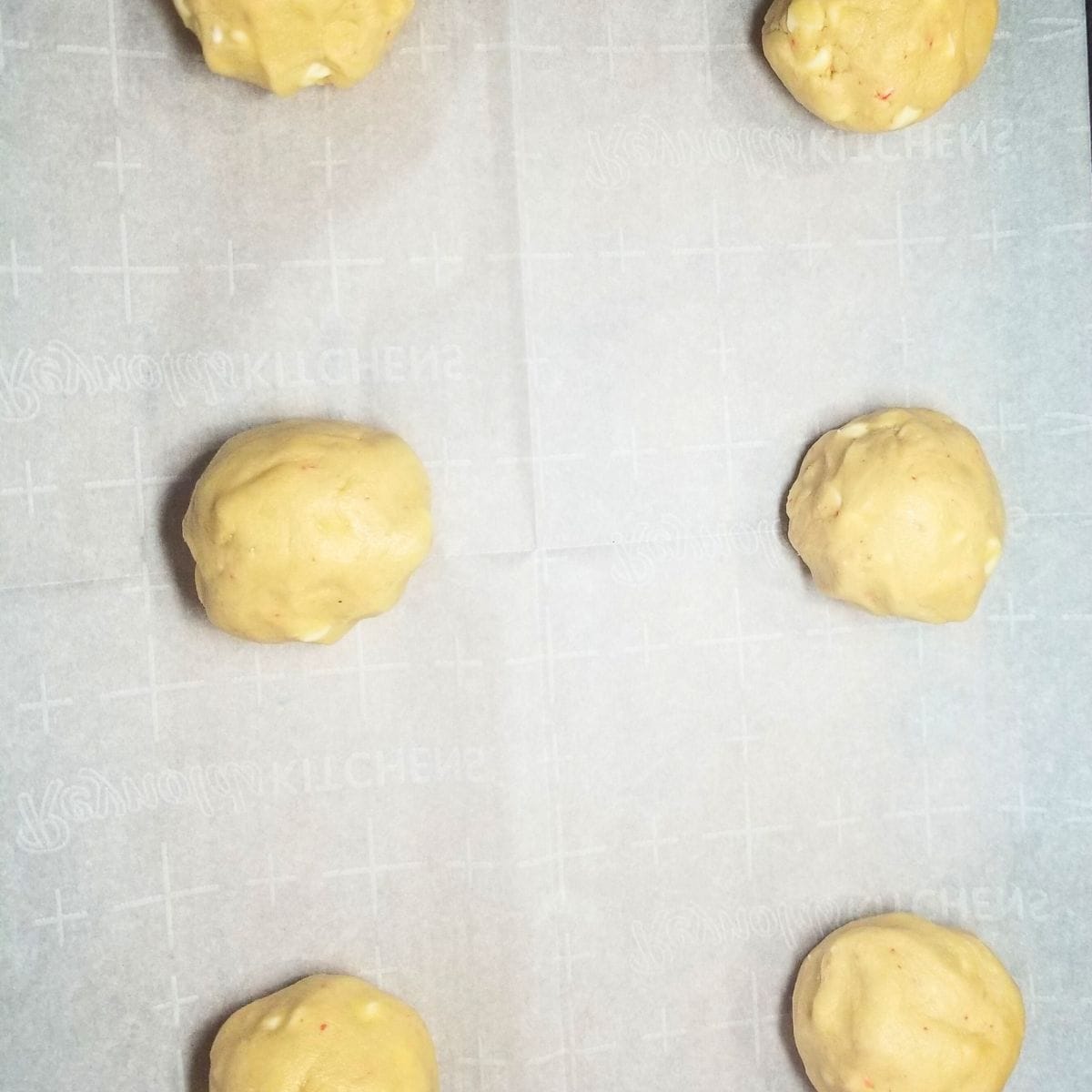 Rolled cookie dough on a parchment paper lined baking sheet.