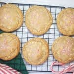 Peppermint cookies on a wire rack with stripped dishtowels and peppermint candy.