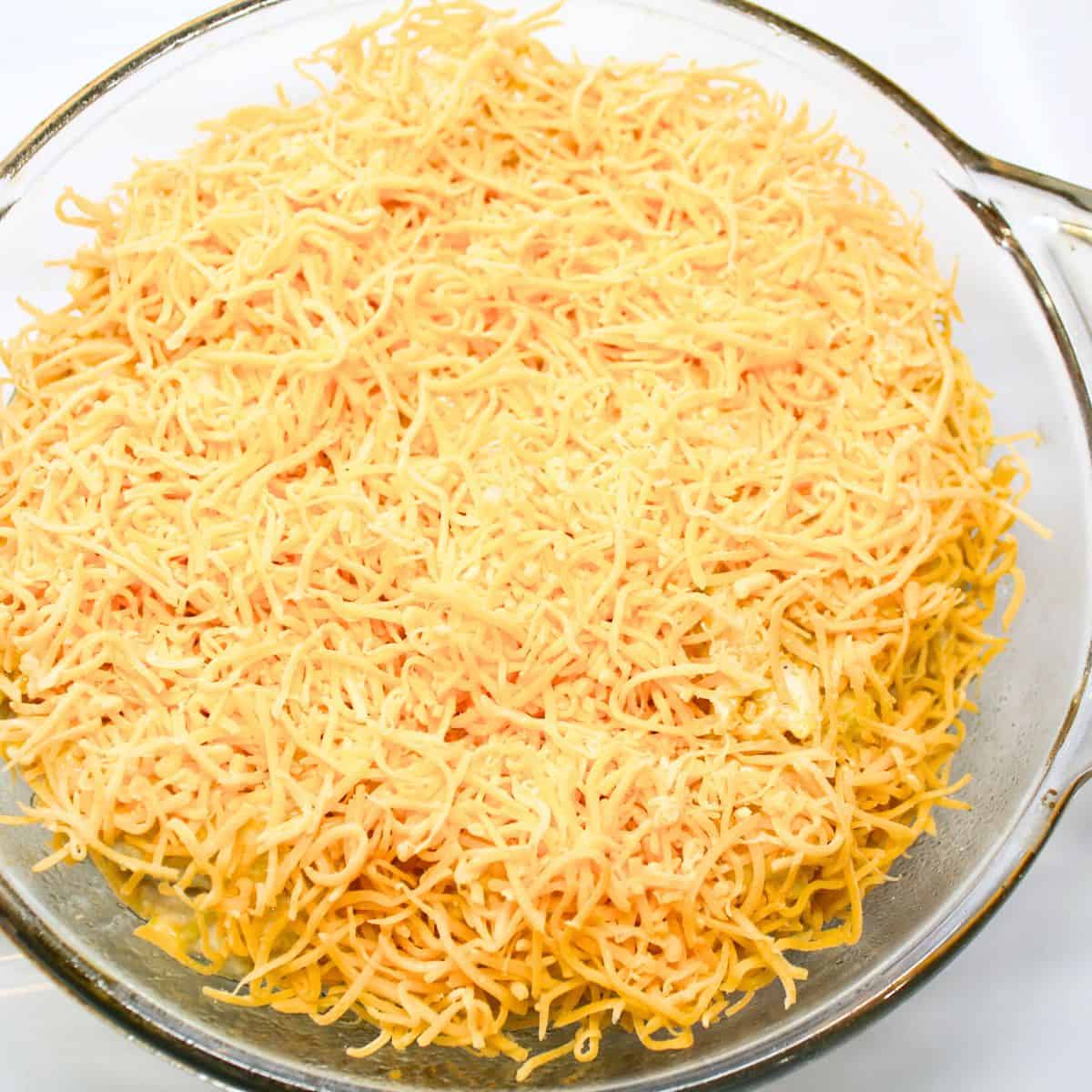 Spoon all of the ingredients in a baking dish and cover with cheese.