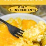 Yellow rice and corn casserole in a baking dish with a fork.