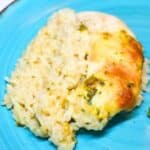 Chicken Rice-A-Roni casserole on a blue plate with green beans.