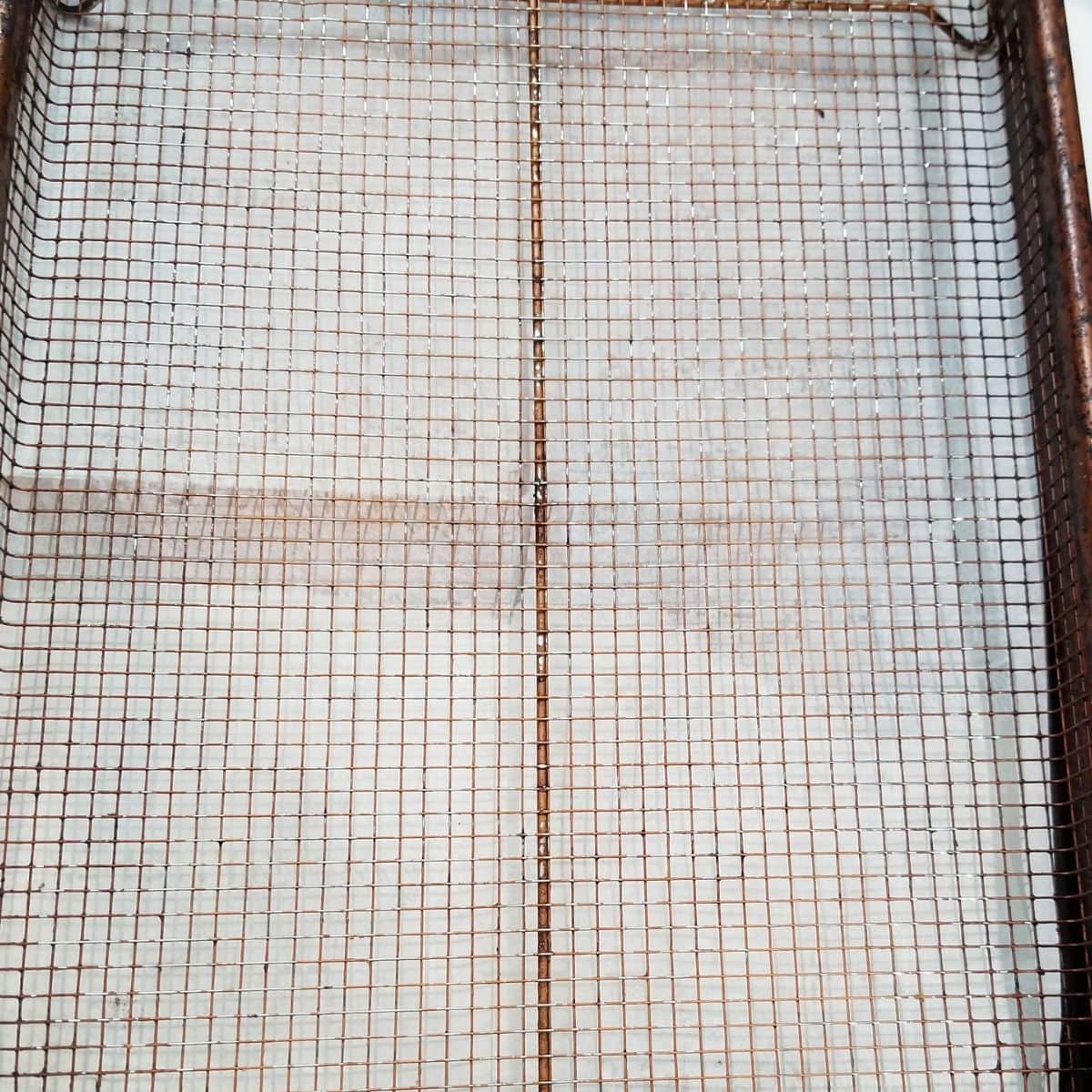 A wire baking rack on a baking pan.