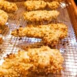 Crispy chicken tenders on a wire baking rack.