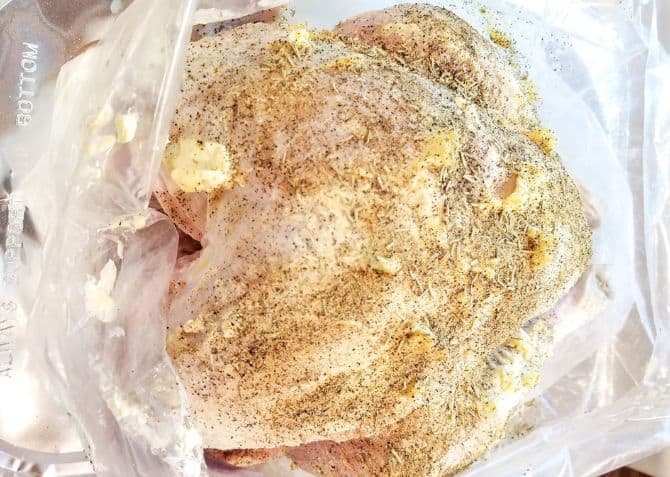 A buttered and seasoned turkey in a Reynolds oven turkey bag.