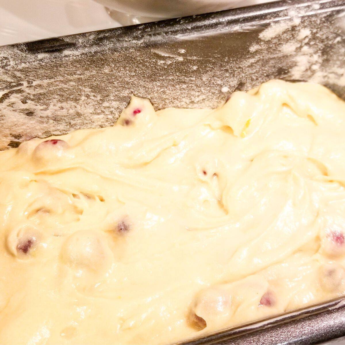 Bread batter in a floured pan ready for the oven.