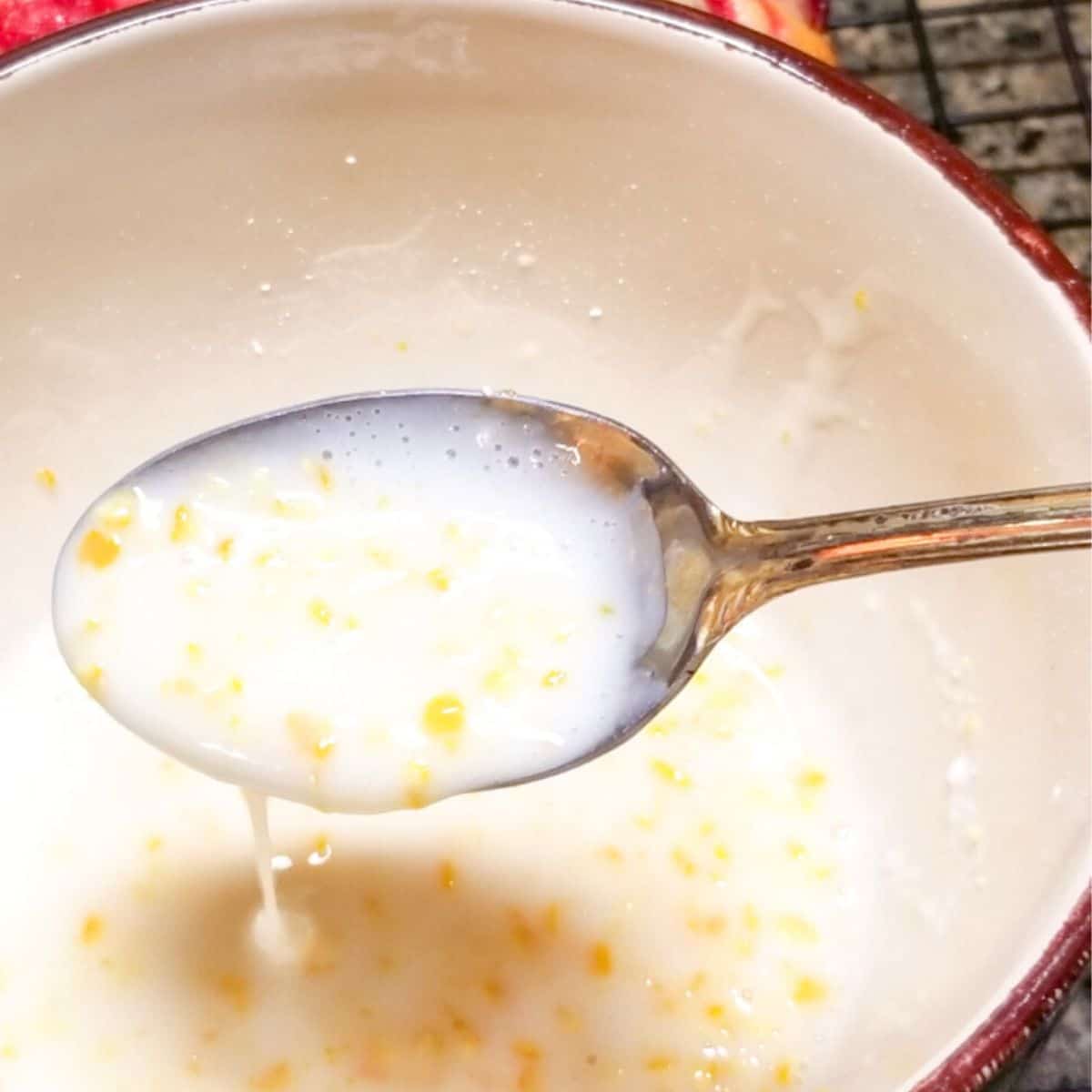 Glaze in a white bowl with a spoon.