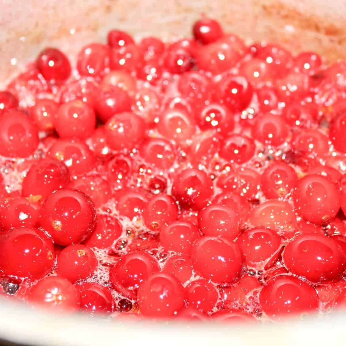 Boiling cranberries in a pot.