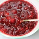 Cranberry Sauce in a bowl with a spoon.