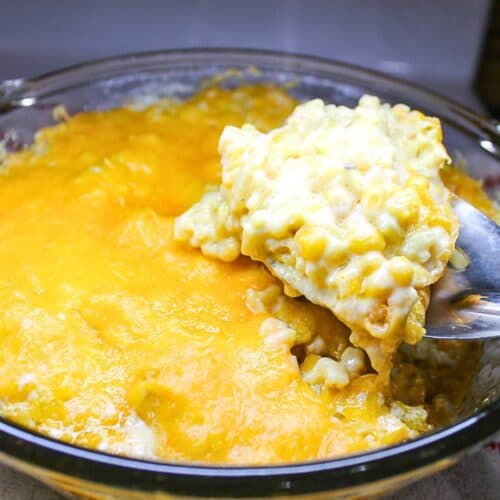 Yellow rice and corn casserole in a baking dish.
