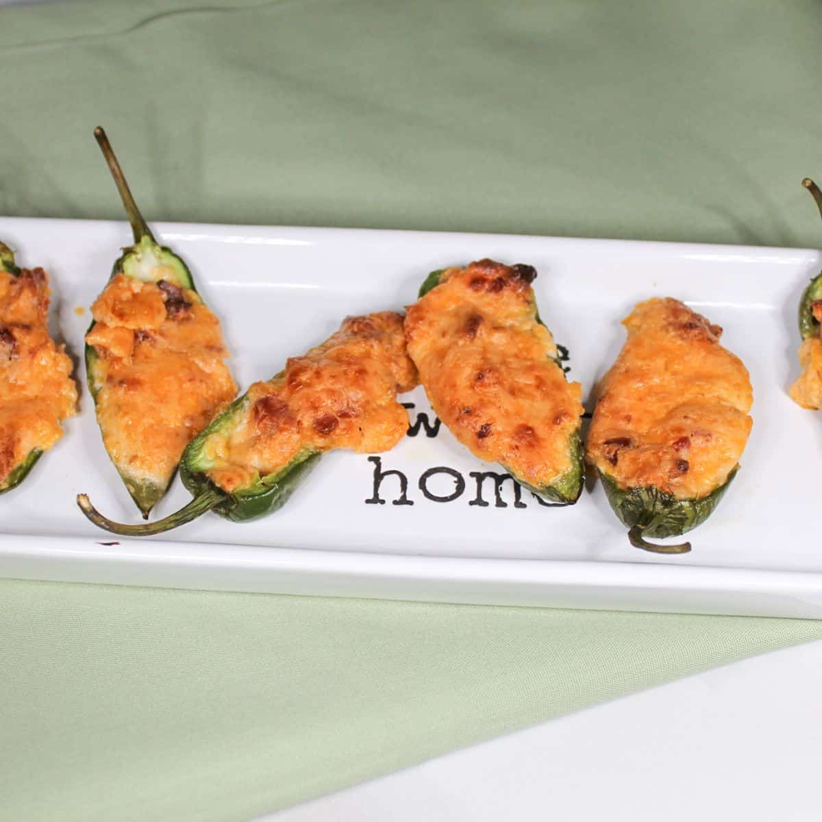 Cheesy Stuffed Jalapeno on a white baking dish.