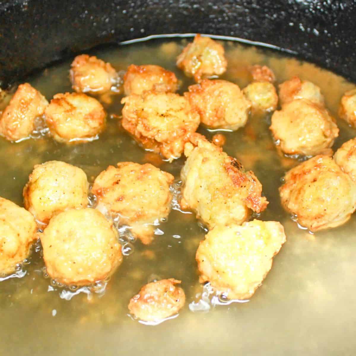Frying okra in a cast iron skillet.