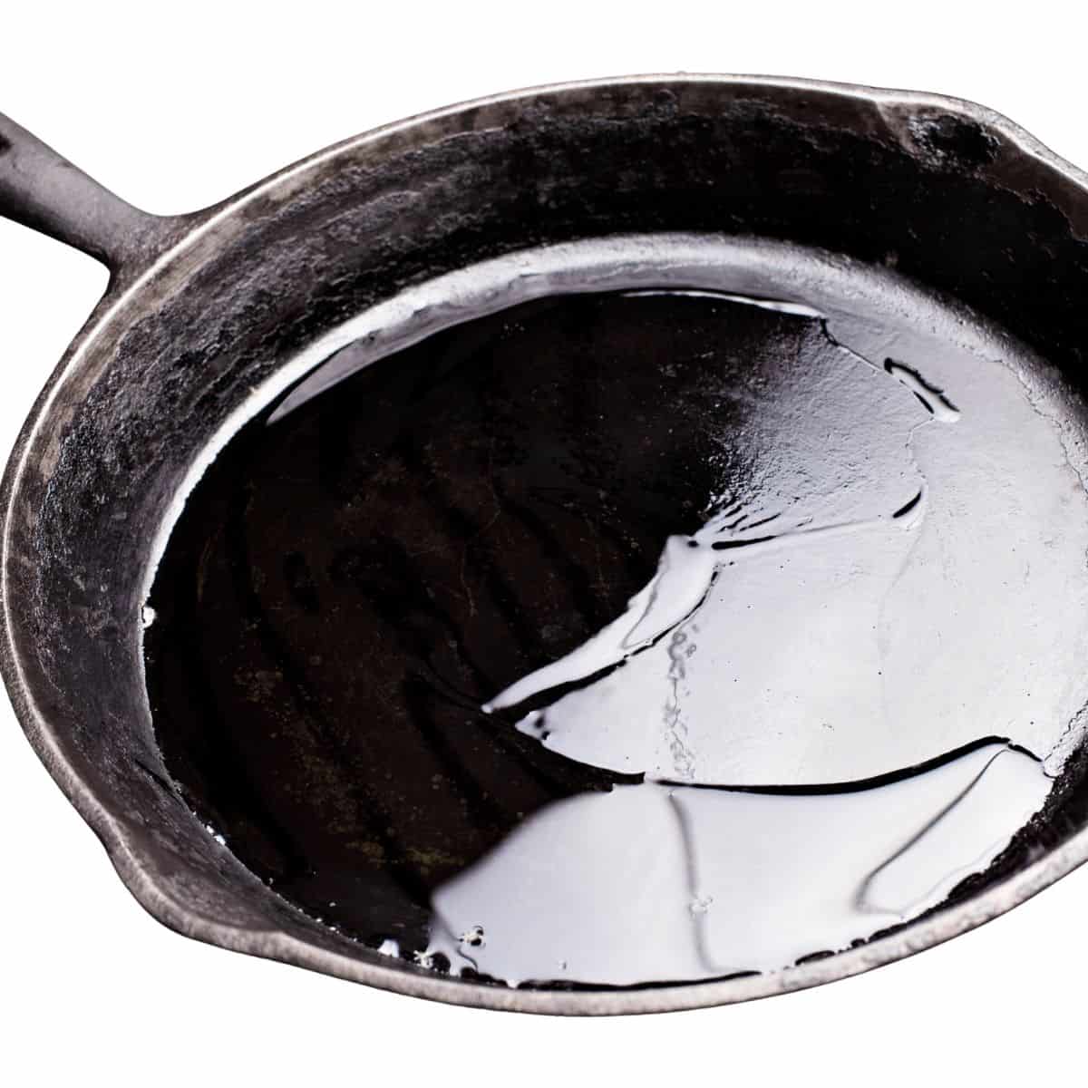 A cast iron skillet with oil in the bottom.
