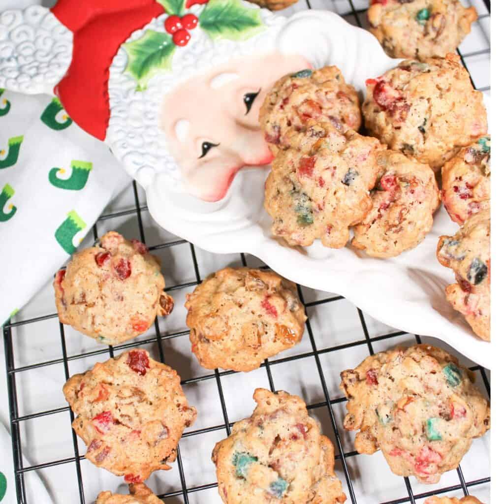Christmas Fruitcake Cookies on a baking rack and plate.