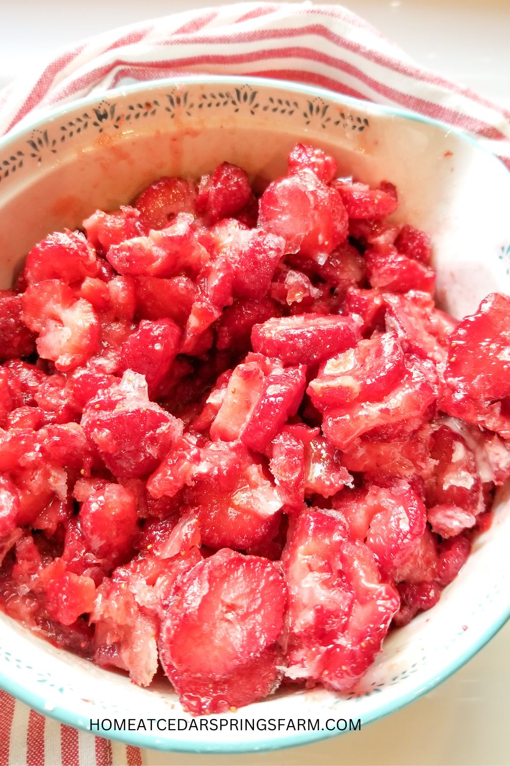 Strawberries in a blue and white bowl.