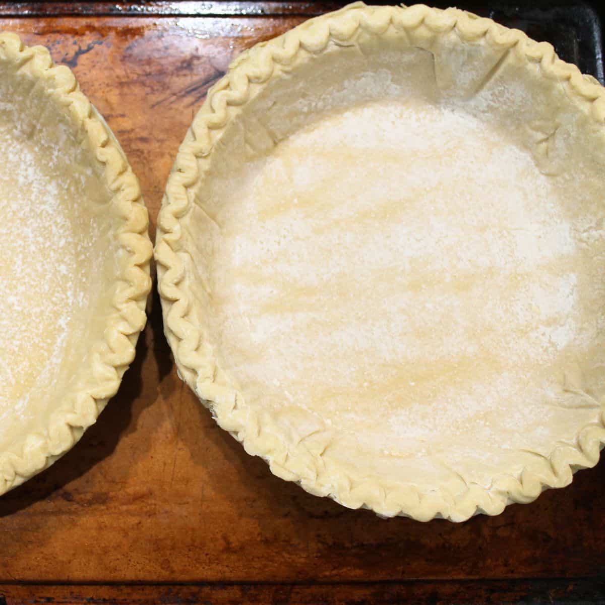 An unbaked pie crust on a baking sheet.