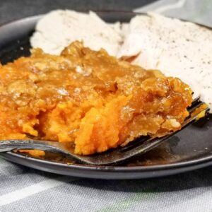 Sweet potato casserole on a plate with turkey