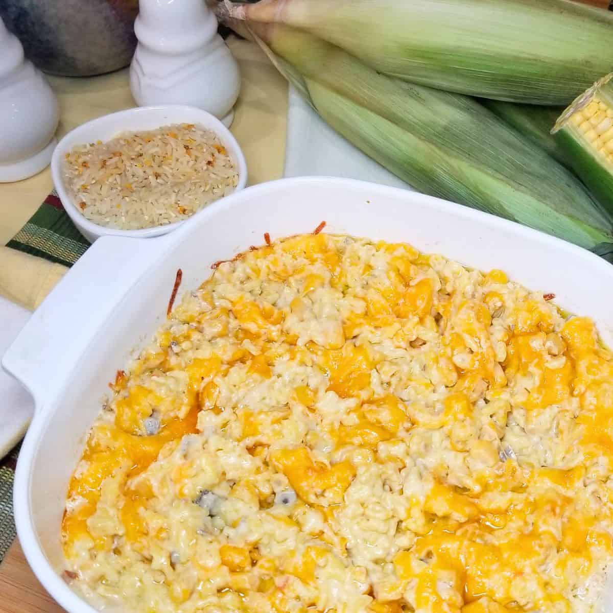 Yellow rice and corn casserole in a baking dish on a table.
